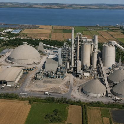 Aerial view of a heavy process plant with kilns, silos and storage domes